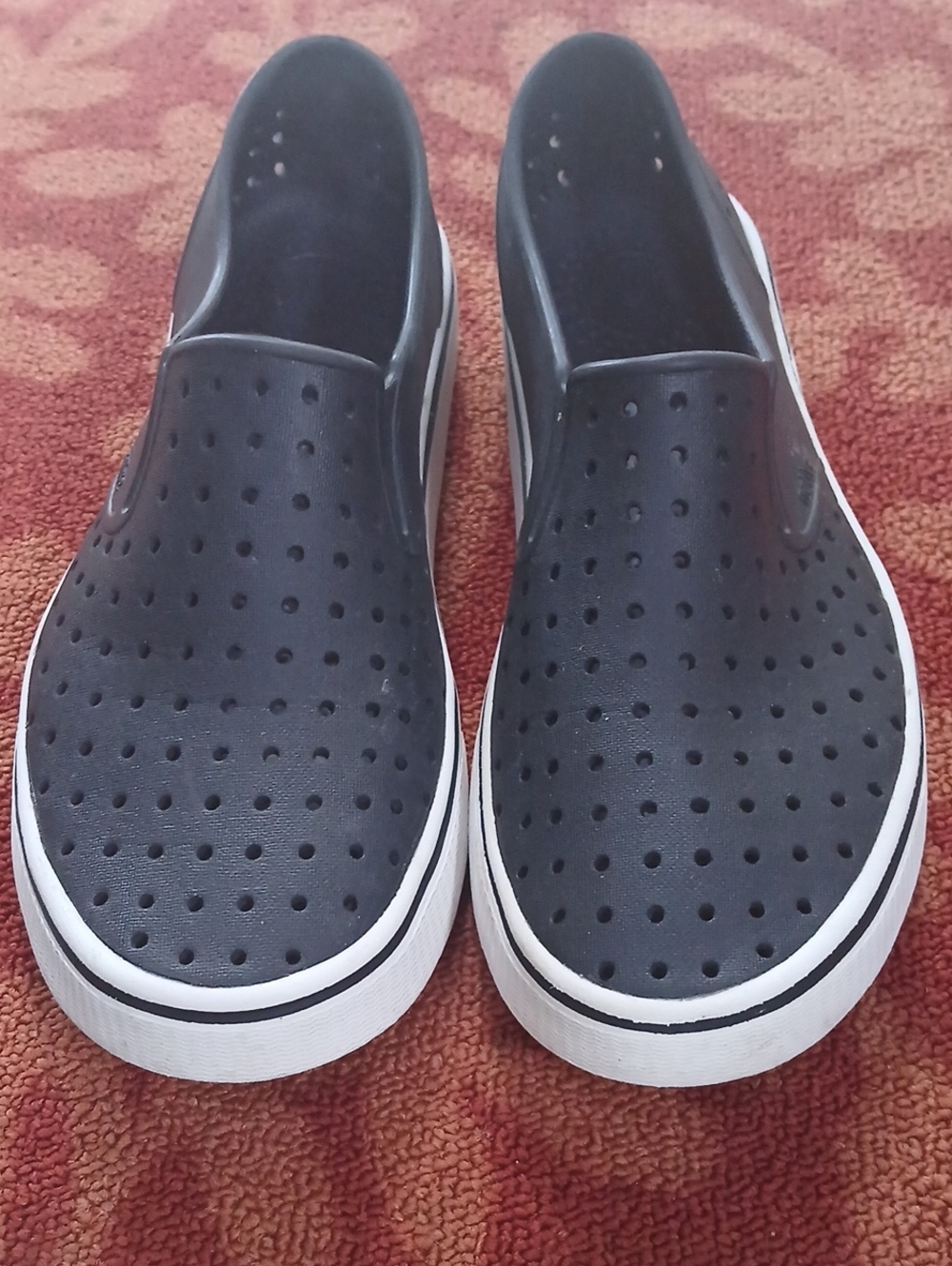 Native Women's Black Perforated Slip-On Loafers with White Sole